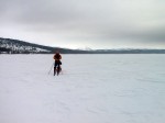 Day 65. Andre skiing down Holden lake on a dull grey day
