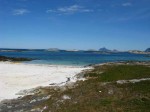 Day 190.1 The beach on Sandvaer whwere i spent the night with numerous skerries and the distinctive profile of Hestmon island in the distance