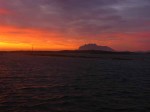 Day 190.6 The sunset from the jetty of the Havnomaden kayak centre with the island of Donna in the distance