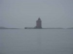 Day 201.1 The lighthouse in the skerries of the coast in Bjugnfjord  seen through the pouring rain