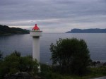 Day 213.1 The lighthouse at Ulvsund is now an automatic beacon with the old building now a nice cafe and in the background is Furenes on Stad